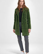 Woman wearing a green coat on a white background