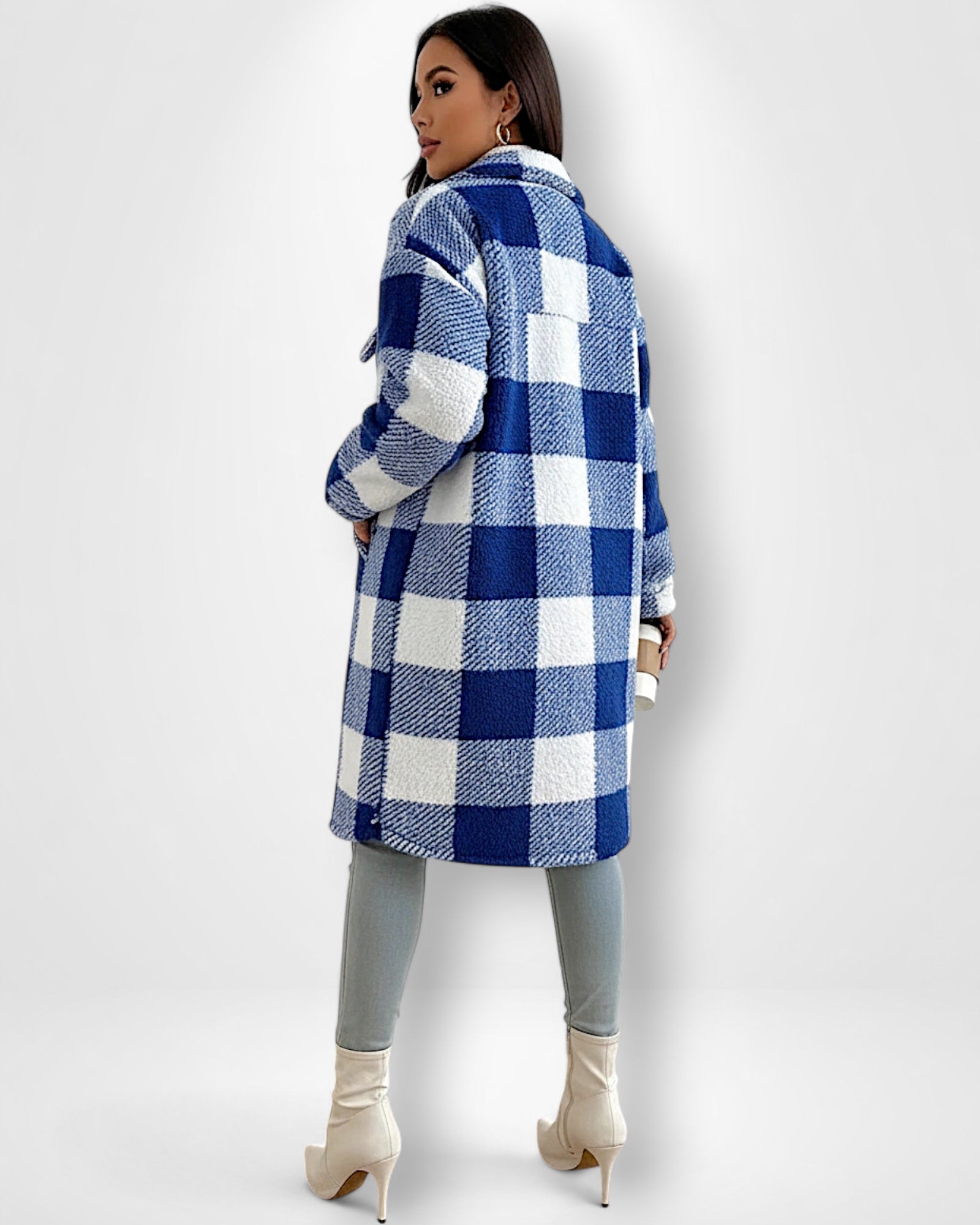 Frau trägt einen blau-weiß karierten Teddy-Mantel