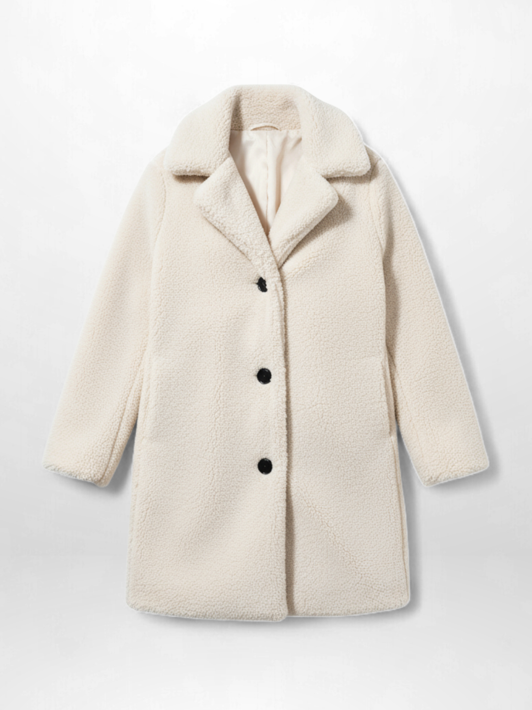 Weißer Teddy-Mantel mit schwarzen Knöpfen vor hellgrauem Hintergrund