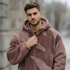 Man wearing a pink camouflage hoodie outdoors